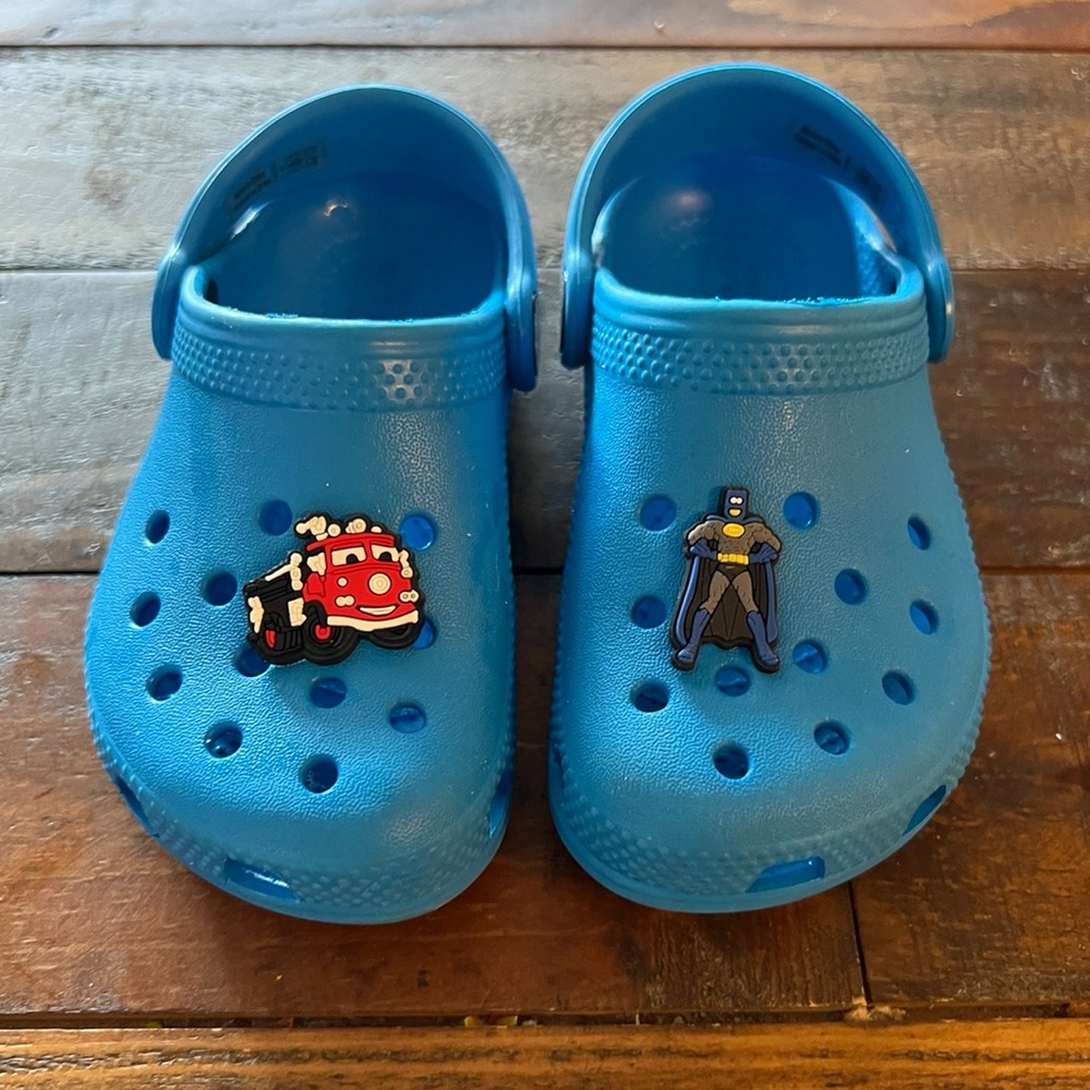Blue Crocs w Batman and Thomas the Train pins. Great condition, size C9